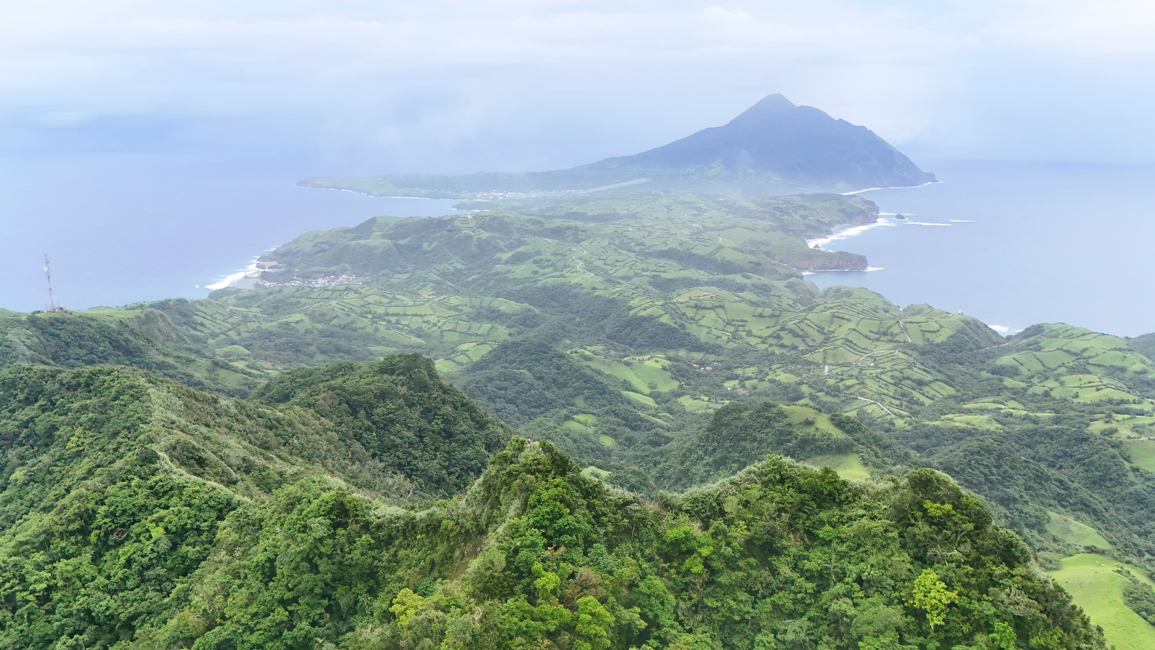 Batanes road unfolding between green hills and the sea