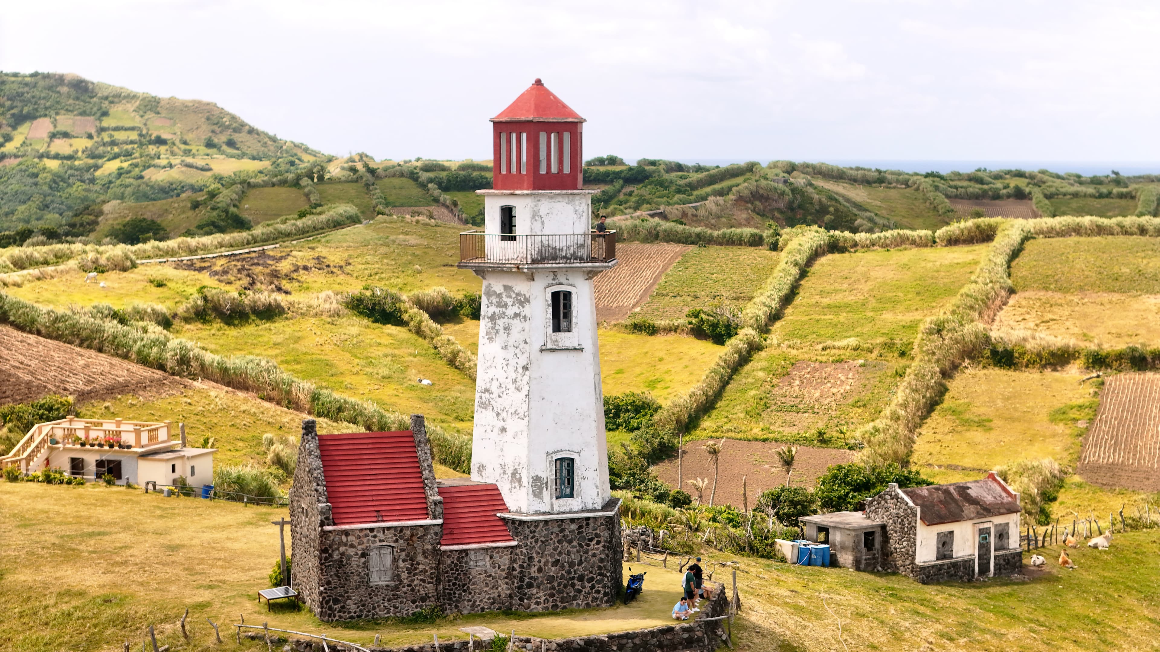 Tayid Lighthouse surrounded by green fields in South Batan
