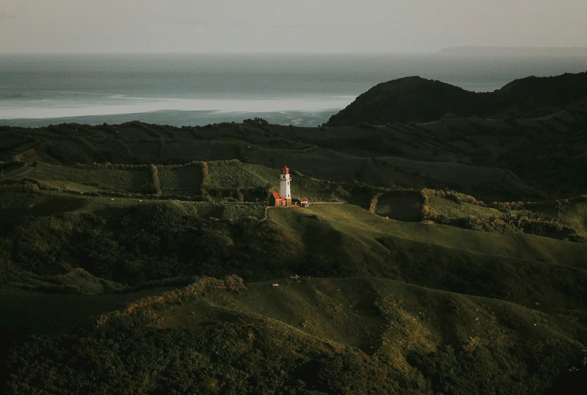 Tayid Lighthouse surrounded by rolling Batanes hills